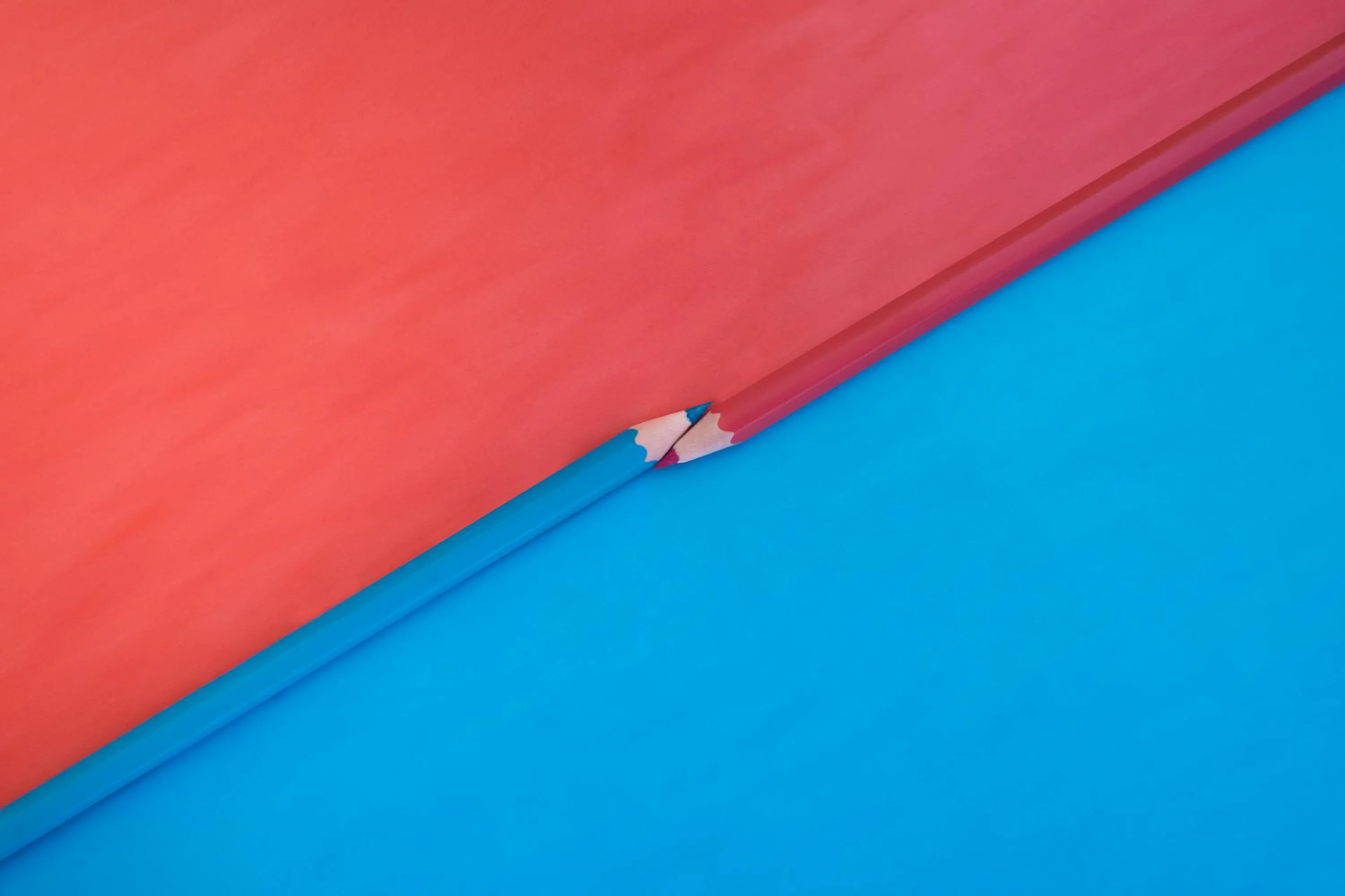 A blue pencil at diagonal to a red pencil, alluding to opposing political parties. The pencils might remind some of voting day.